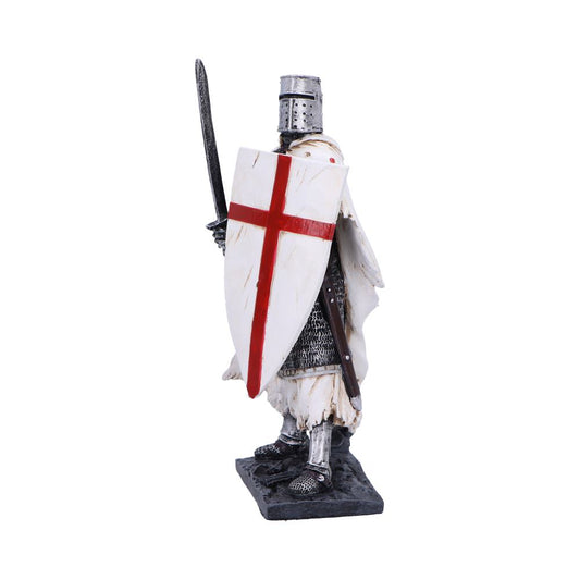 Medieval knight figurine holds an upright sword and bears a white heater shield with a red cross while standing on a rocky base against a plain white background.