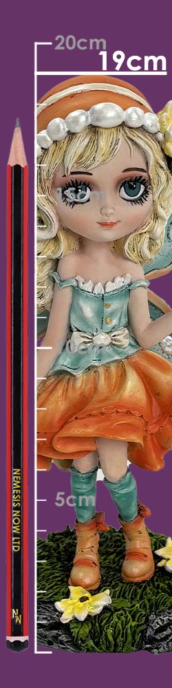 Porcelain blonde doll stands on a grassy base wearing a teal top and orange skirt beside a pencil and white measurement marks on a purple background; text: 20cm 19cm 5cm NEMESIS NOW LTD NN