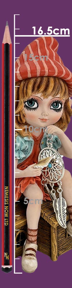 A small seated girl figurine holds a dreamcatcher and feather while sitting on a wooden crate against a purple background with a measuring pencil and ruler markings; text: 16.5cm 15cm 10cm 5cm NEMESIS NOW LTD ZN
