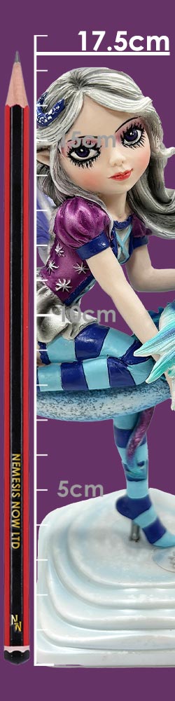 Stylized elf-like fairy figurine with silver hair and large eyes sits on a white tiered base wearing purple and teal striped clothing while a red-and-black pencil and ruler markings read 17.5cm 15cm 10cm 5cm and NEMESIS NOW LTD.