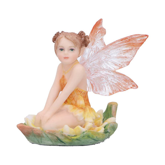 Porcelain fairy figurine sitting with hands on her knees, gazing forward, perched on a green and yellow flower-petal base with translucent orange-veined wings against a plain white background.