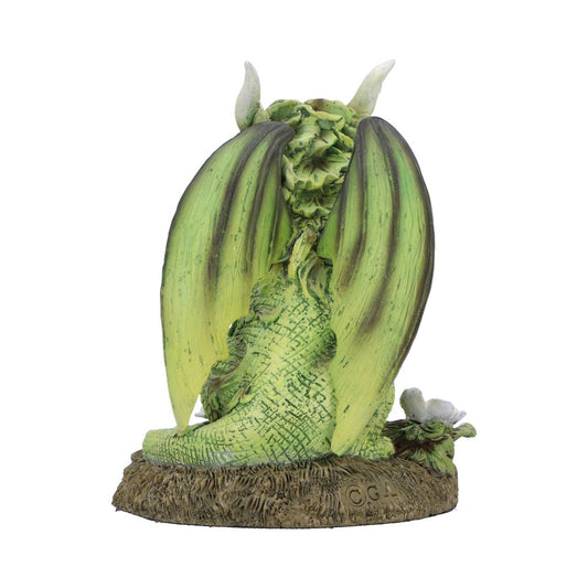 Green dragon figurine sits curled with folded wings and small horns, perched on a textured brown base with a white flower against a plain white background; text on base: © G A