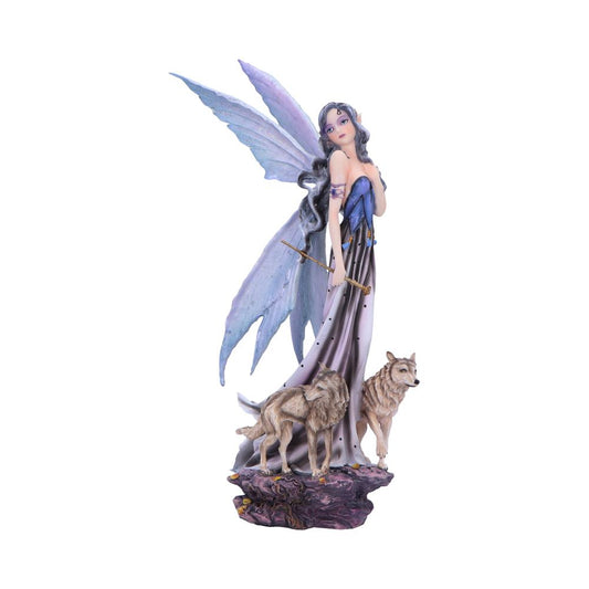 Fairy figurine stands poised, holding a golden staff and gazing over her shoulder, wearing a flowing purple-blue gown and iridescent wings, on a rocky base beside two wolves.