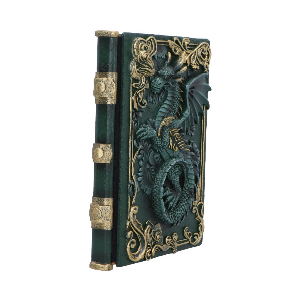 Ornate green leather book displays a sculpted dragon coiling across its gold-accented cover while standing angled against a plain white background.