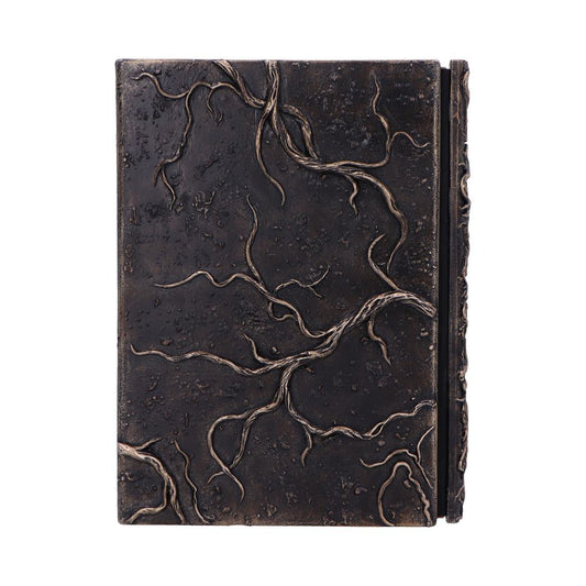 Ornate leather-bound journal rests closed on a white background, its dark cover embossed with twisting roots and raised veins, elastic strap secured along the spine.