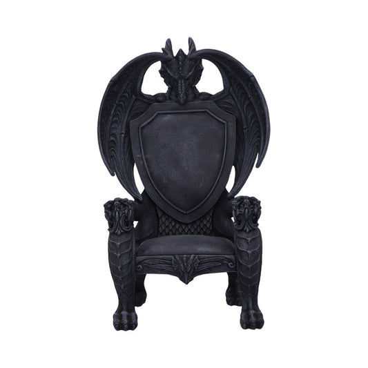 A black gothic throne shaped like a dragon with a dragon head at the top, wings forming the backrest, a shield-shaped back, clawed legs and lion-like armrests isolated on a white background.