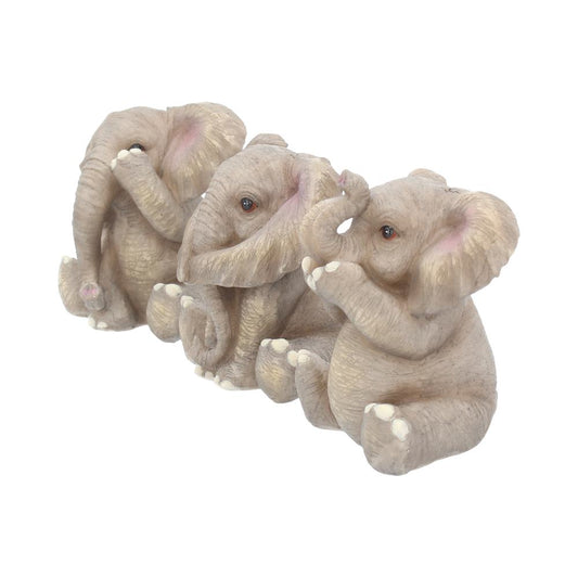Three gray elephant figurines sit in a row, each with a different hand-to-face pose: one covers its mouth, another covers its ears, and the last covers its eyes. The background is white.