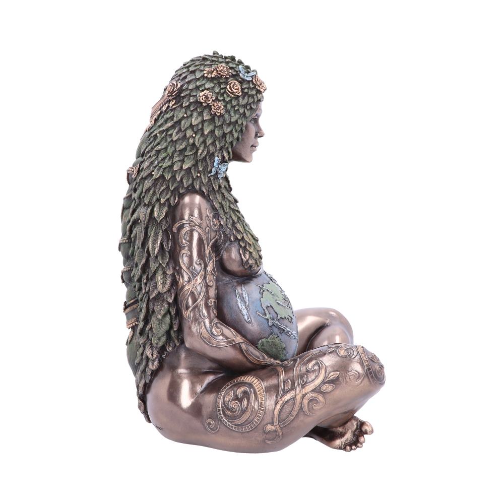 A seated statue depicts a pregnant woman with intricate body tattoos and hair made of leaves and flowers, cradling a globe on her belly, set against a plain white background.