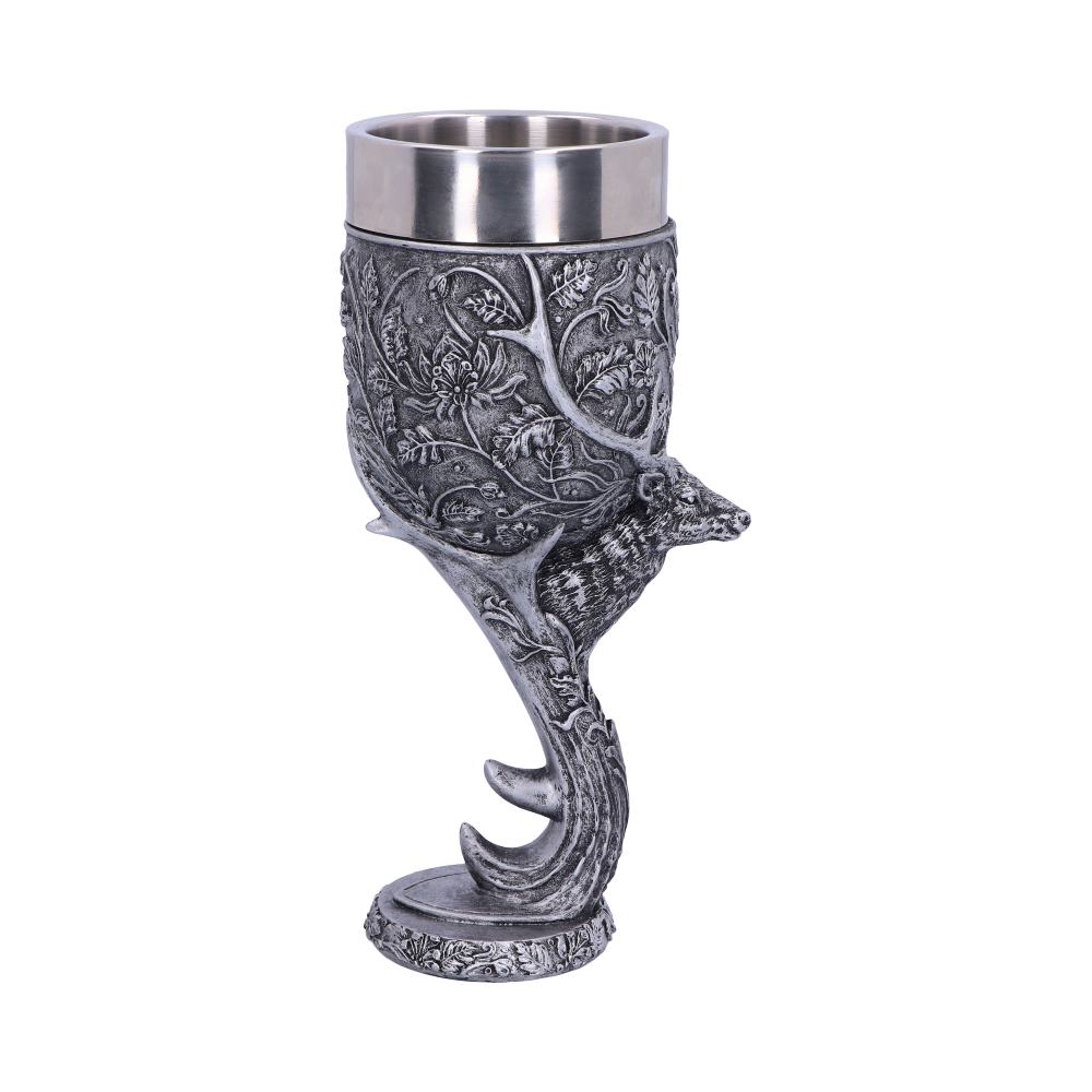 A silver goblet is decorated with leaf patterns and a deer; the goblet is supported by deer antlers on a white background.