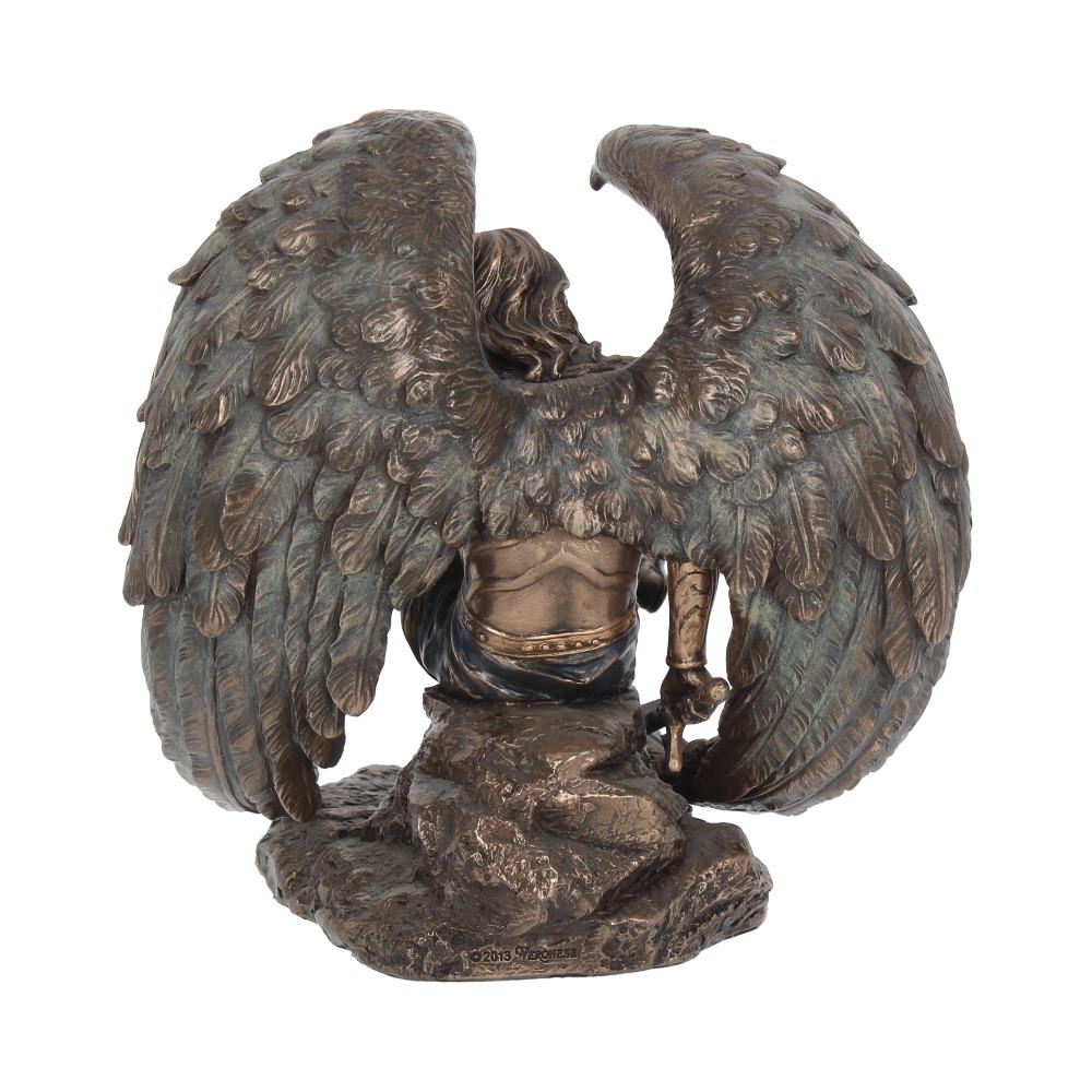 A bronze angel kneels, from the rear, on a rocky base with wings spread wide. The figure is wearing armor with a sword held at his side. On the base is written "©2013 VERONESE".