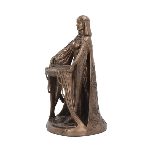 A bronze-colored statue depicts a robed female figure standing with arms outstretched, holding a circular object. The statue's intricate design includes flowing robes and a detailed base.