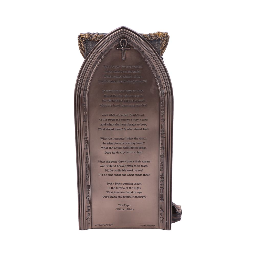 A framed carving displays the poem "The Tyger" by William Blake, with an Ankh symbol at the top and hieroglyphic-like designs along the sides. The text of the poem is legible.