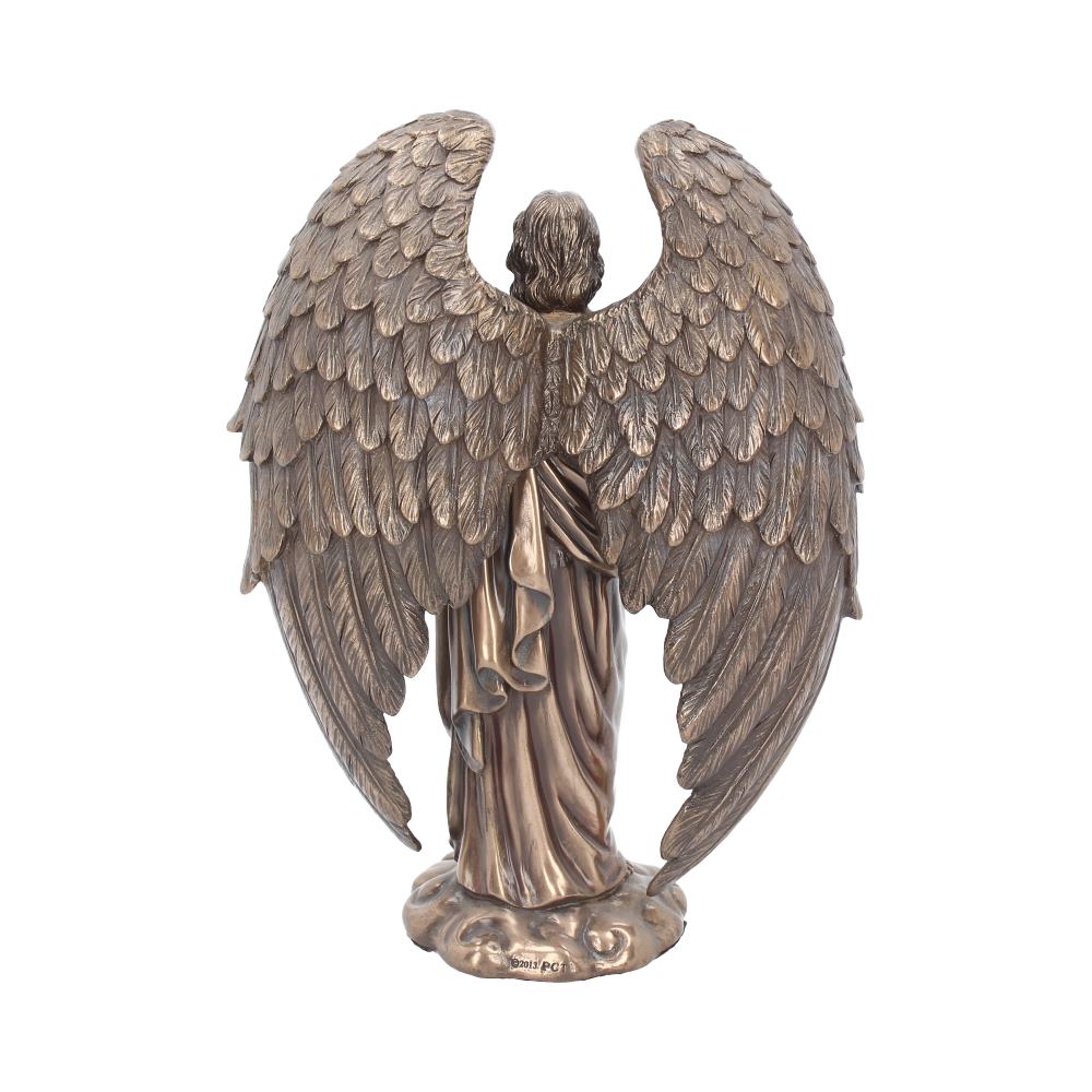 A bronze angel statue stands facing away with large, feathered wings spread, on a base of swirling clouds. "@2013/PC" is printed on the base.