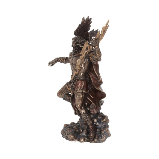 Bronze-toned statue depicts a powerful figure wielding lightning, standing on a rocky base, adorned in warrior attire with a feathered helmet, evoking a mythical or god-like presence in dynamic motion.