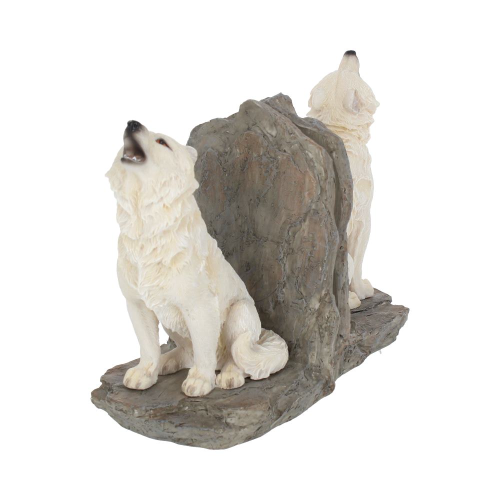 Two white wolf sculptures sit and howl on rocky bases, separated by a stone-like divider, forming decorative bookends.