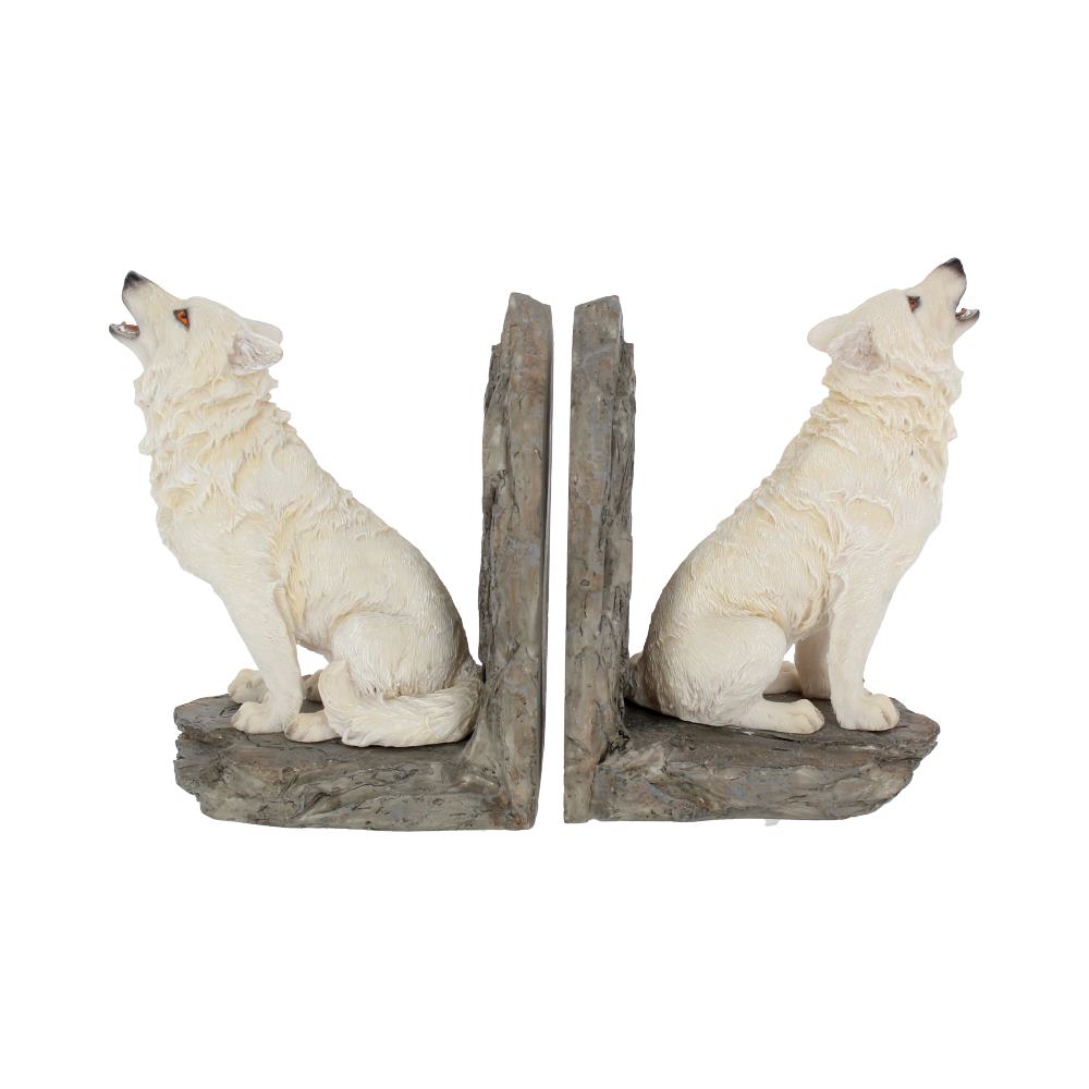 Two white wolf sculptures, posed as if howling, sit facing opposite directions on textured stone-like bookends, creating an earthy, decorative set.