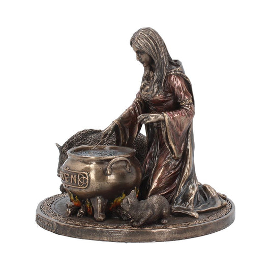 A bronze-colored statue features a cloaked woman stirring a cauldron labeled "CERIDWEN," with a pig by her side, amidst a detailed, circular base with Celtic designs.