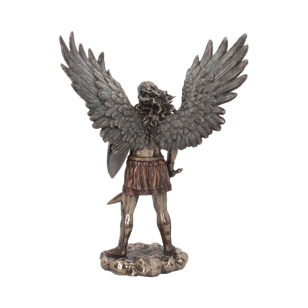 A statue of an angel stands on a cloud-like base with its wings spread, facing away. It holds a shield in one hand and a sword in the other.