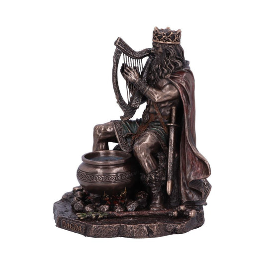 A detailed statue depicts a bearded figure playing a harp, seated next to a cauldron over flames. "DAGDA" is inscribed on the base, embodying a mythological or historical theme.