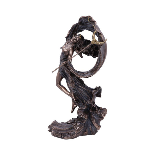 A bronze statue depicts a flowing, robed figure holding a crescent-moon staff aloft, entwined in swirling waves of fabric, creating a sense of dynamic motion against a plain background.