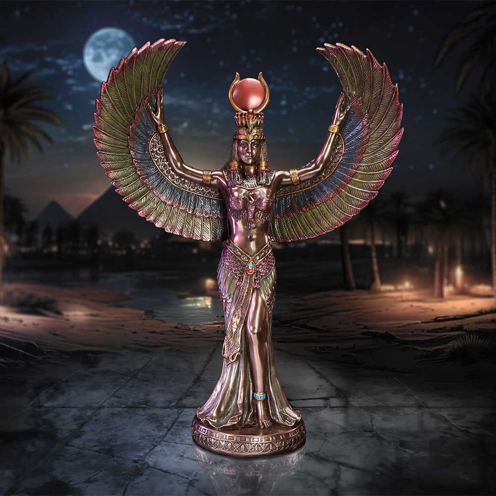 Bronze statuette of an Egyptian goddess raises ornate feathered wings while standing on a decorative base in a moonlit desert with palm trees, pyramids and scattered torchlight in the background.