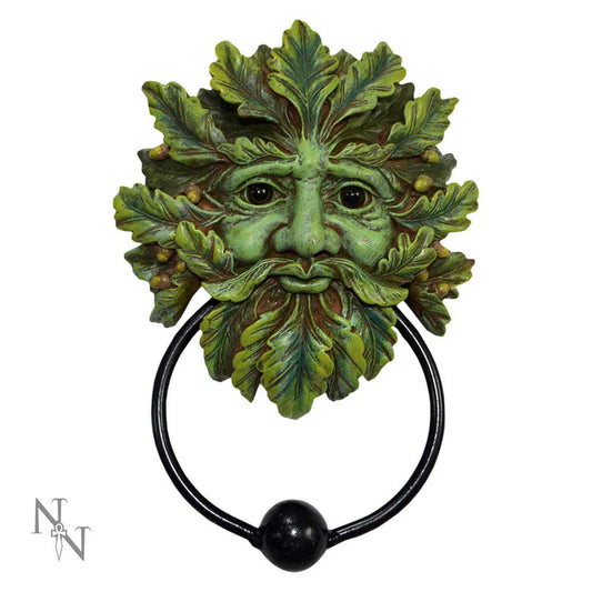 A decorative door knocker features a face made of green leaves with a black metal ring beneath, set against a plain white background. The letters "N" and "W" are in the bottom left corner.