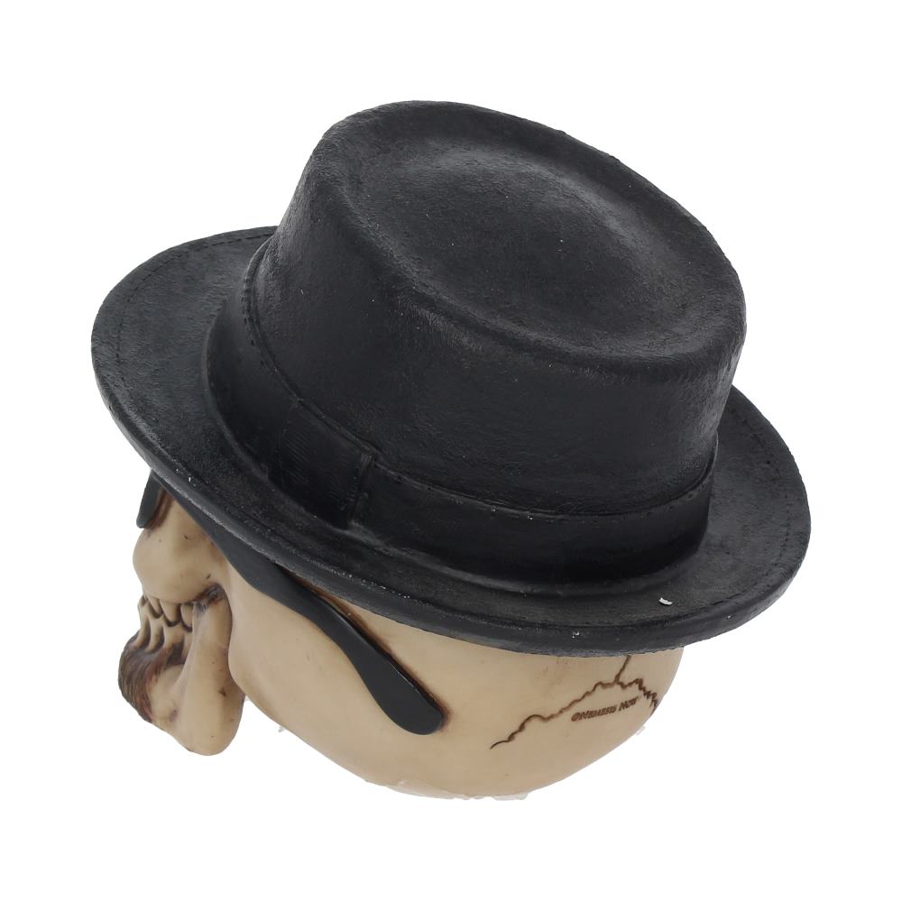A decorative skull wears a black fedora and dark sunglasses, positioned against a plain white background. The skull is detailed with cracks and shading, enhancing its realistic appearance.