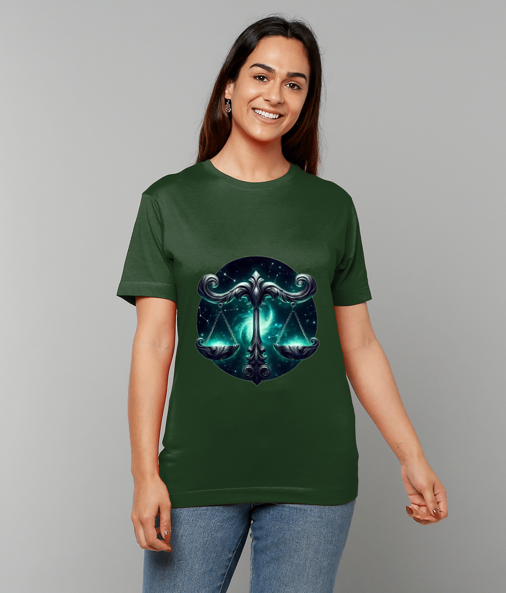 Ornate metallic scales hover over a teal-blue nebula on a green T-shirt, worn by a smiling person standing against a plain gray background.