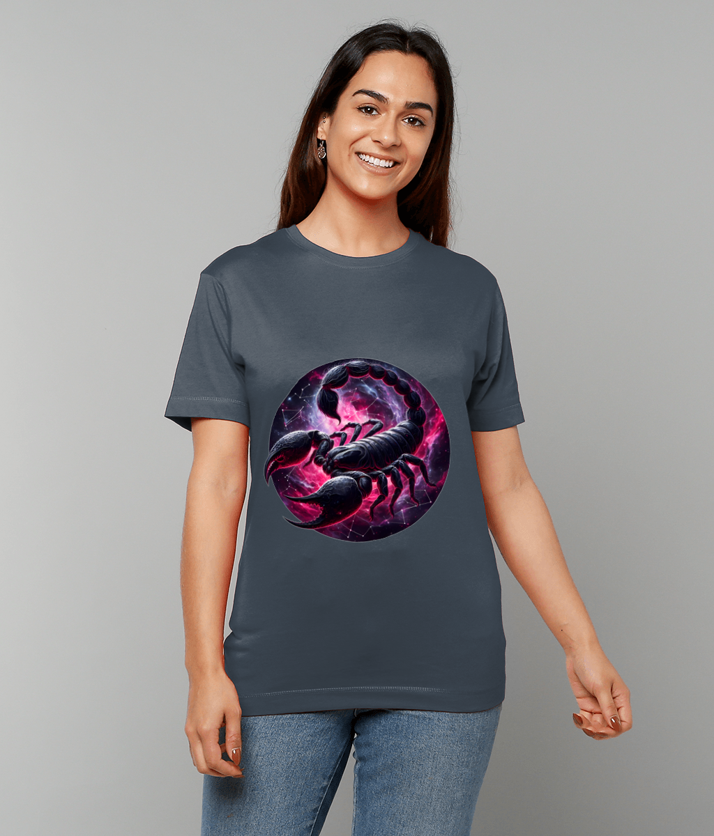 Dark gray T-shirt displaying a large circular purple-pink nebula with a detailed black scorpion graphic; person smiles while standing against a plain light gray studio backdrop.