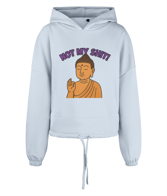 Light blue cropped hoodie displays an orange Buddha with a raised hand in a blessing gesture and purple text above reading NOT MY SHIT! on a plain black background.