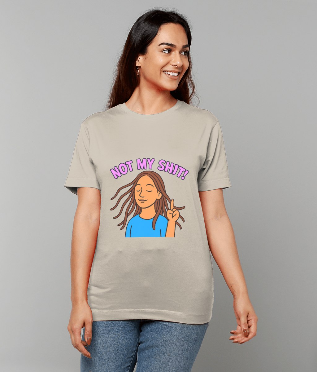 Young woman wearing a beige T-shirt displaying the text "NOT MY SHIT!" above a cartoon woman with closed eyes and a raised index finger, standing against a plain gray background.