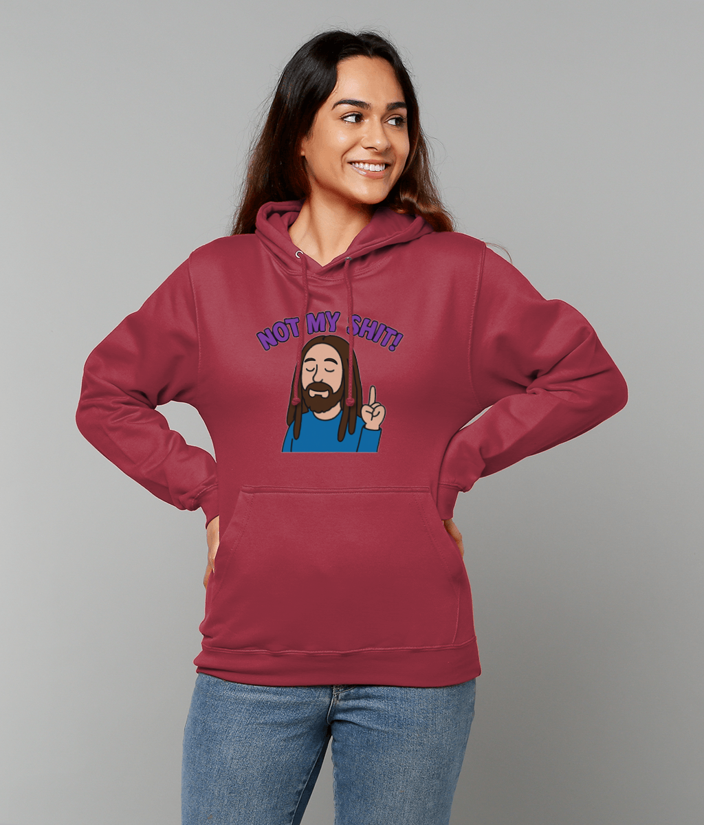 Woman wearing maroon hoodie printed with cartoon bearded man raising one finger and text "NOT MY SHIT!" smiles with hands on hips against a plain light gray studio background.