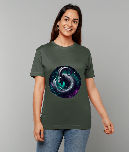 Olive green t-shirt featuring a circular cosmic ram illustration, worn by a smiling person standing with relaxed arms against a plain light gray background while wearing jeans.
