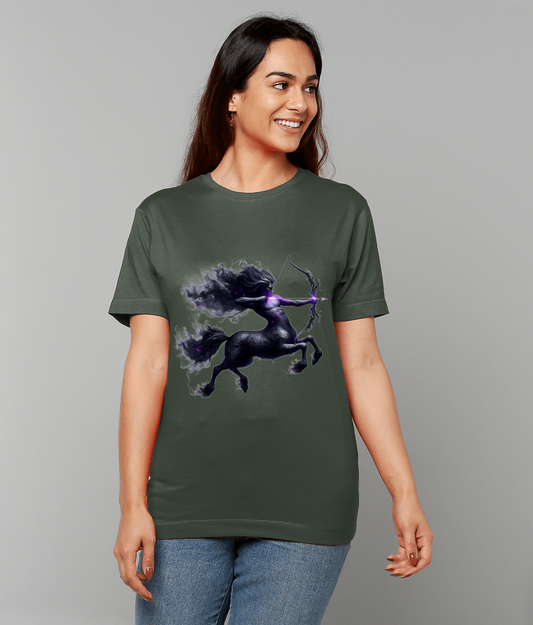 Olive green T-shirt displaying a dark centaur archer rearing and drawing a glowing purple bow, worn by a smiling woman standing against a plain light gray background.