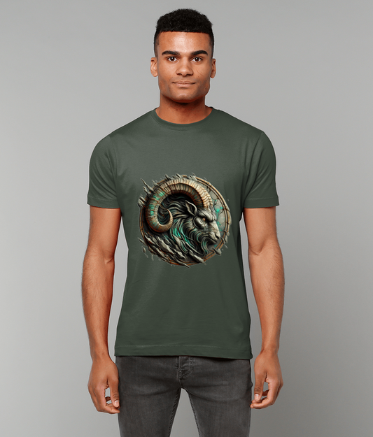 Man wearing a forest-green T-shirt printed with a stylized ram head graphic, standing facing the camera with relaxed arms at his sides against a plain light gray background.