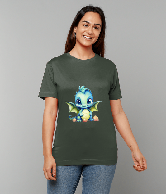 Blue baby dragon holding an egg sits centered on a dark green T-shirt worn by a smiling woman standing against a plain light gray background.