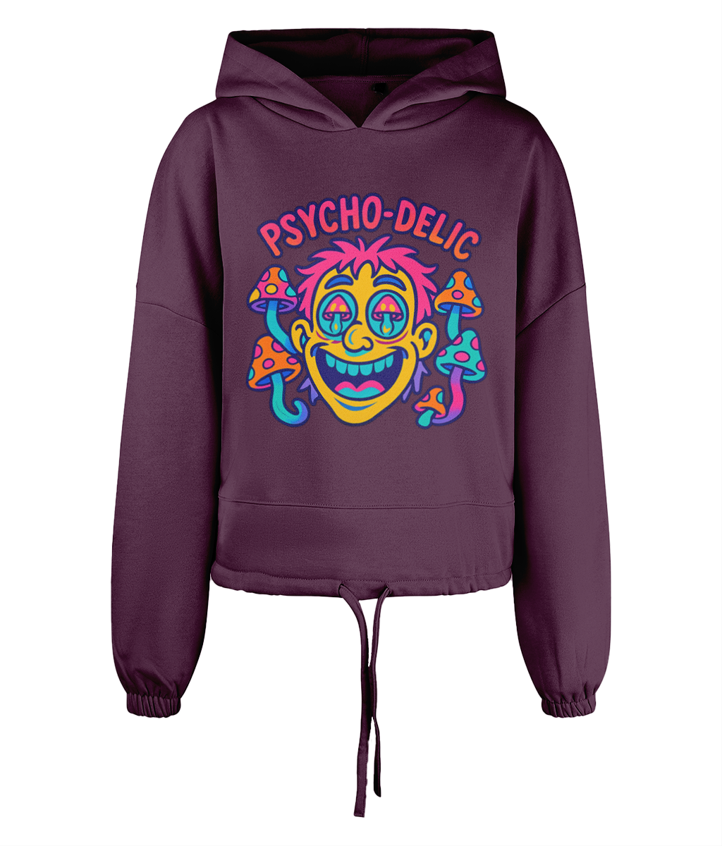 Purple cropped hoodie displays neon cartoon face with mushrooms and text "PSYCHO-DELIC" centered on the chest, set against a black background.
