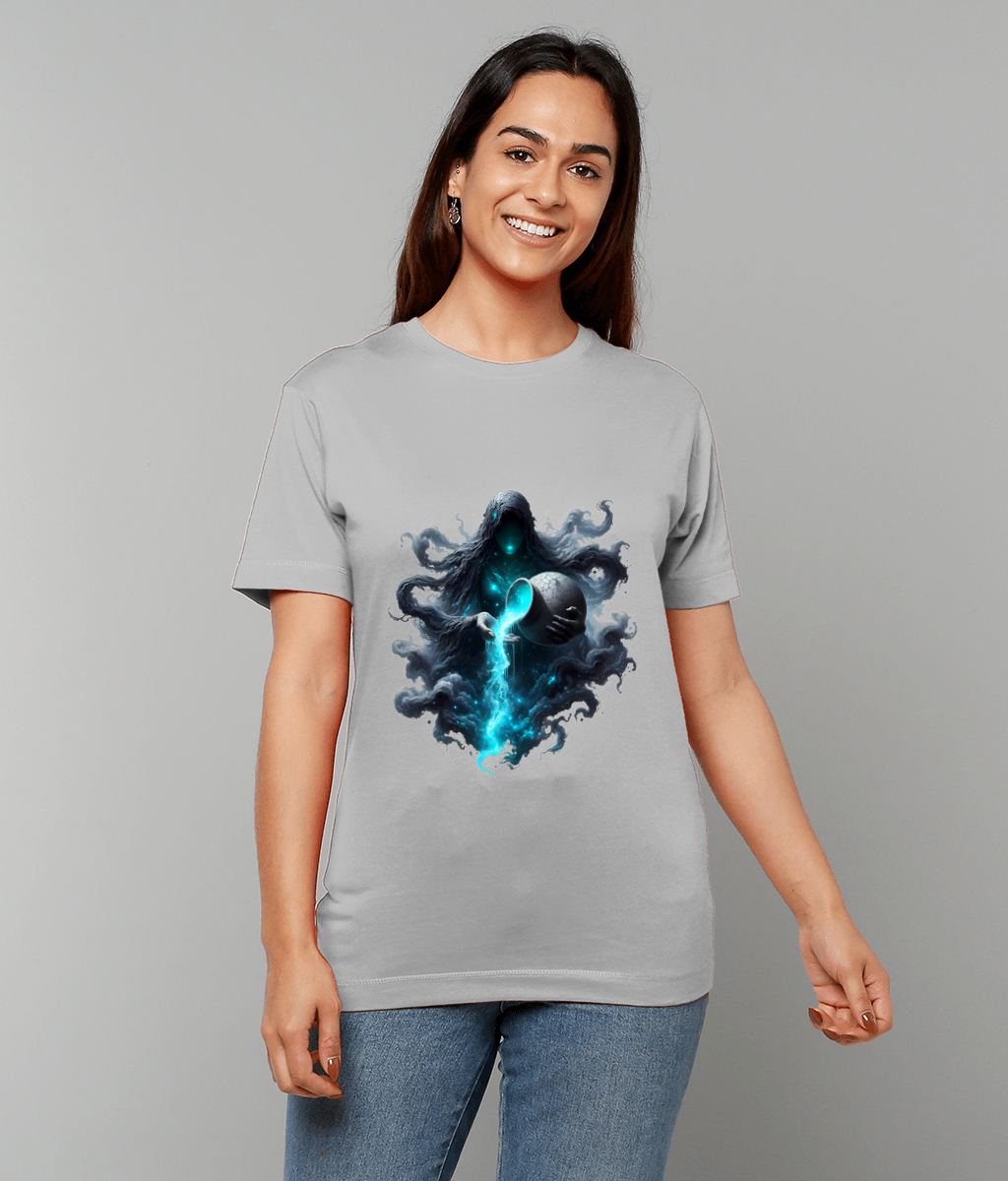 Smiling woman stands wearing a light gray T-shirt displaying a glowing blue spectral robed figure pouring energy from a sphere, her arms relaxed, against neutral gray background while wearing jeans.