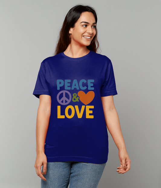 A smiling woman wears a blue T-shirt printed with PEACE & LOVE, standing relaxed with hands at sides against a plain light gray background.