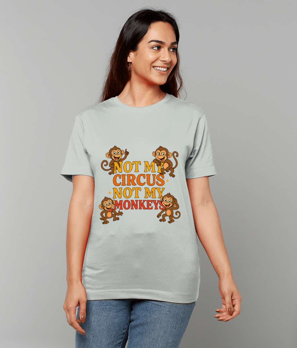 T-shirt displaying cartoon monkeys and text "NOT MY CIRCUS NOT MY MONKEYS", worn by a smiling woman looking right against a plain gray background.