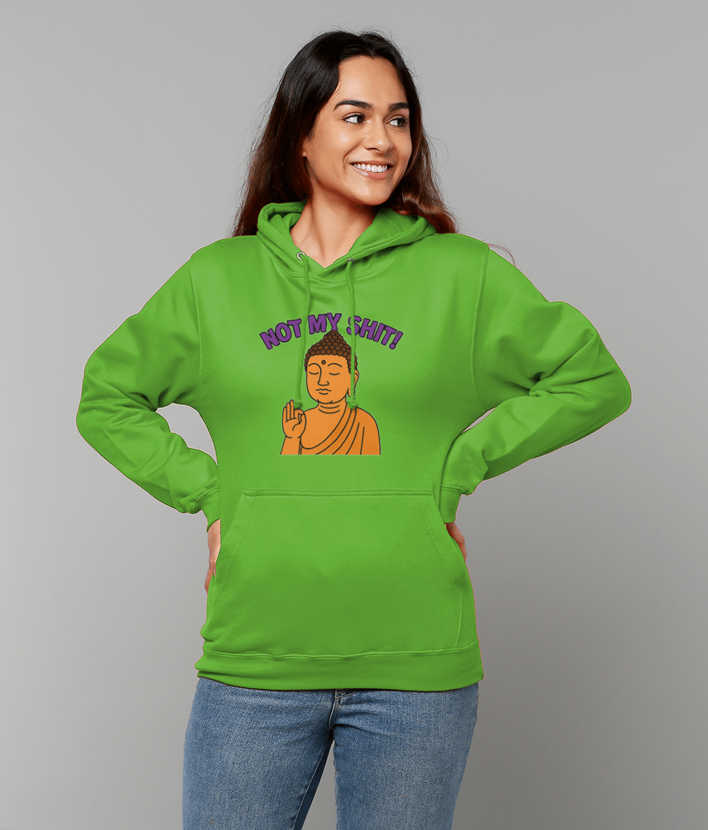 Green hoodie printed with NOT MY SHIT! above a cartoon Buddha, worn by a smiling woman with hands on hips, looking to the side against a neutral gray studio background.