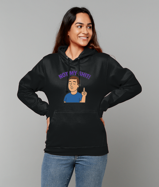Woman wearing a black hoodie reading "NOT MY SHIT!" with a cartoon figure, smiling with hands on hips against a plain light gray background, blue jeans visible.