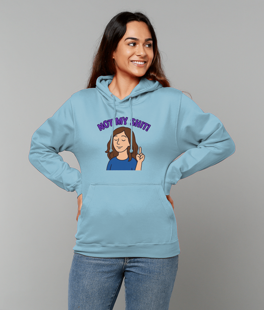 Woman wearing a light blue hoodie printed NOT MY SHIT! raises an index finger and smiles in a neutral studio setting.