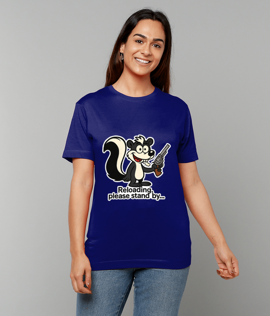 Cartoon skunk on a blue T-shirt is holding a revolver while a smiling woman stands against a plain gray background, text reads "Reloading, please stand by..."