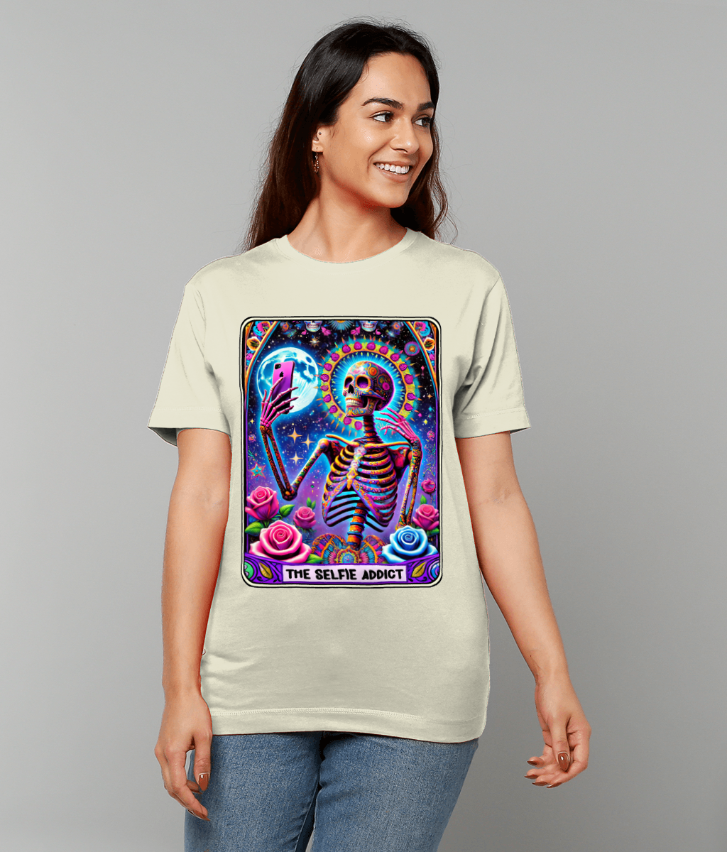 T-shirt shows a colorful skeleton taking a smartphone selfie against a cosmic starry background with roses; text "THE SELFIE ADDICT" appears below.