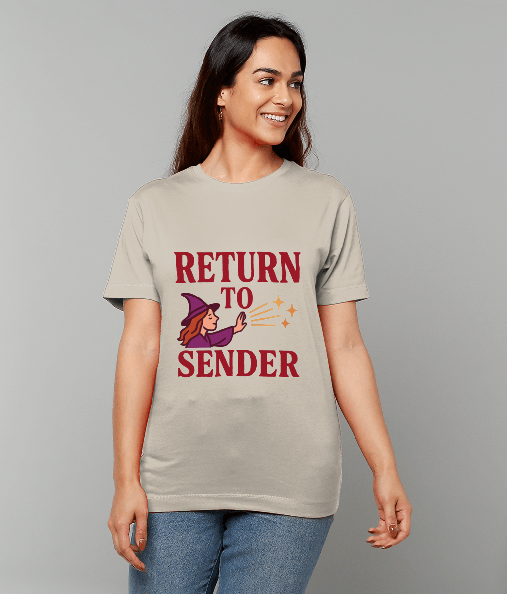 T-shirt reading RETURN TO SENDER with an illustrated witch casting sparkles, worn by a smiling woman standing against a plain light gray background.