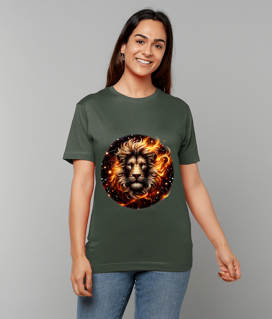 An olive-green T-shirt featuring a circular flaming lion face graphic worn by a smiling person standing against a plain light-gray background.