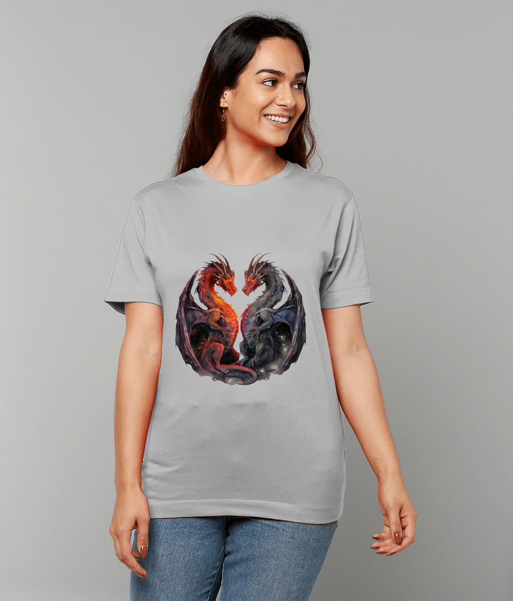 Two mirrored dragons form a heart-shaped embrace on a light gray T-shirt, printed front and center while a smiling person models it against a plain gray background.