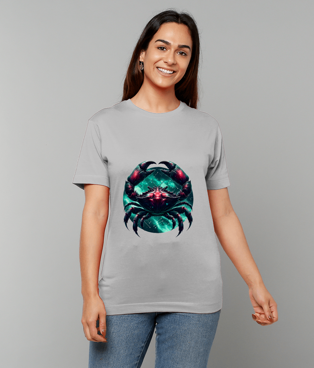 Stylized teal and magenta crab graphic centered on a light gray T-shirt, displayed on a smiling person standing against a plain gray background with hands relaxed at their sides.