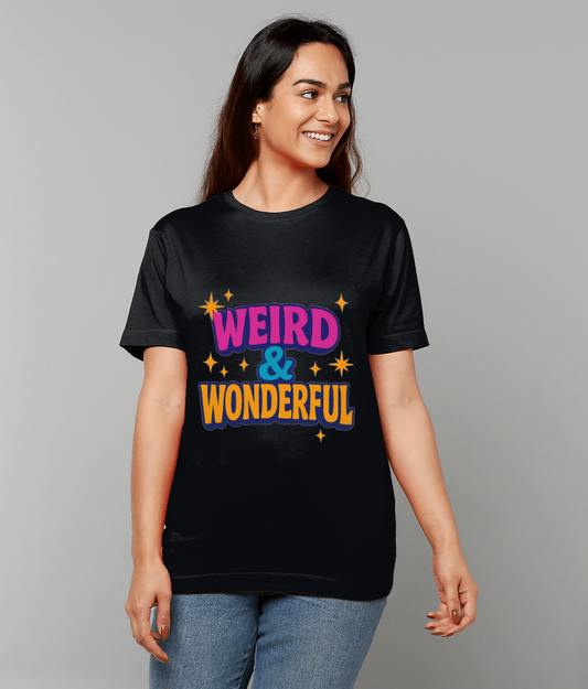 Woman wearing a black T-shirt reading WEIRD & WONDERFUL, smiling and looking to her left, standing with relaxed hands in front of a plain light gray background.